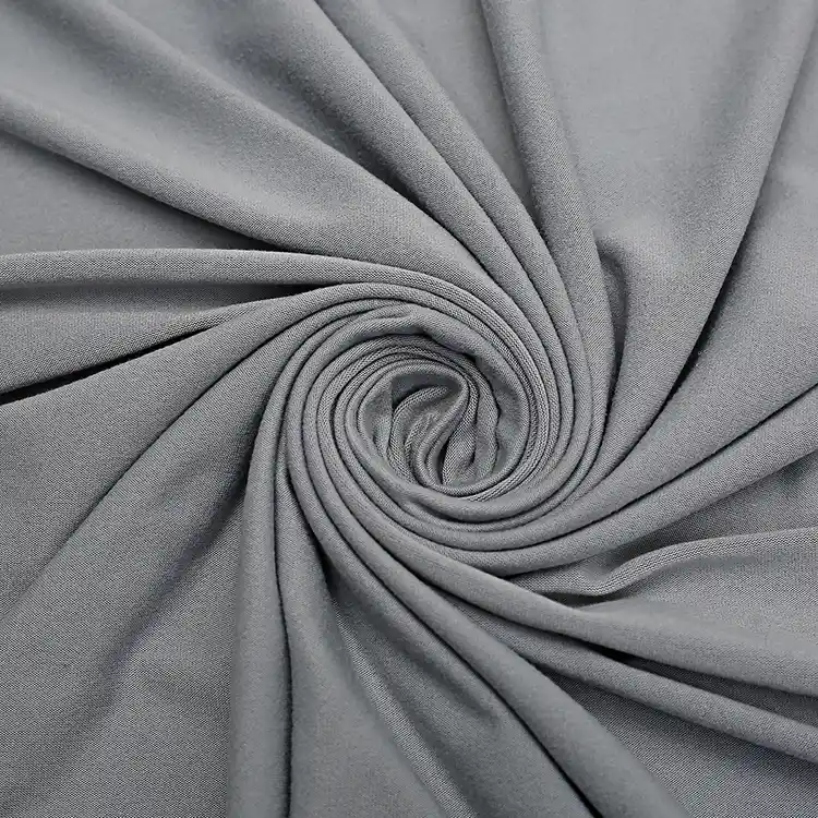 Swaddle blanket wrapped around a baby dummy to show size and coverage