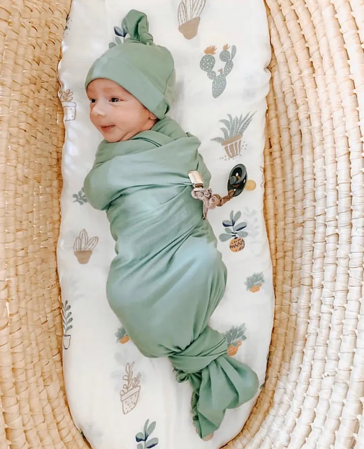Swaddle blanket spread flat with vibrant pattern and soft texture visible