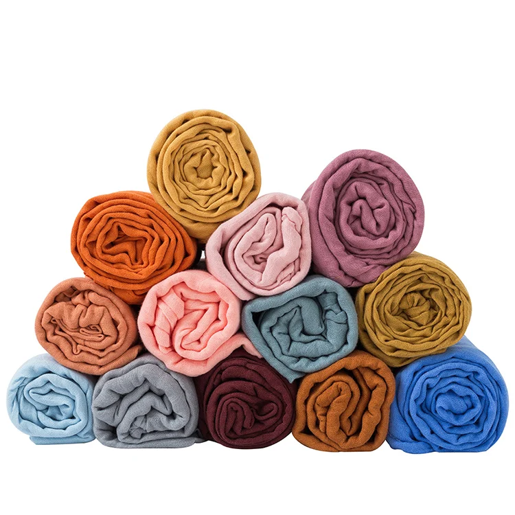 Pink 47x47 inch cotton bamboo muslin swaddle blanket laid flat