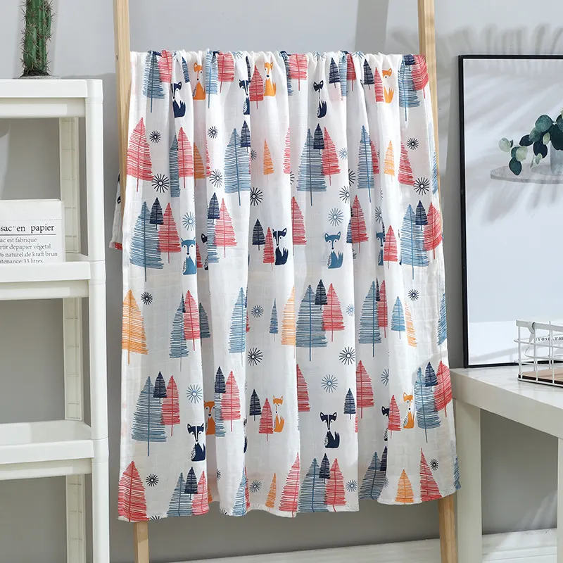 Multiple swaddle blankets in different patterns displayed in a gift set arrangement