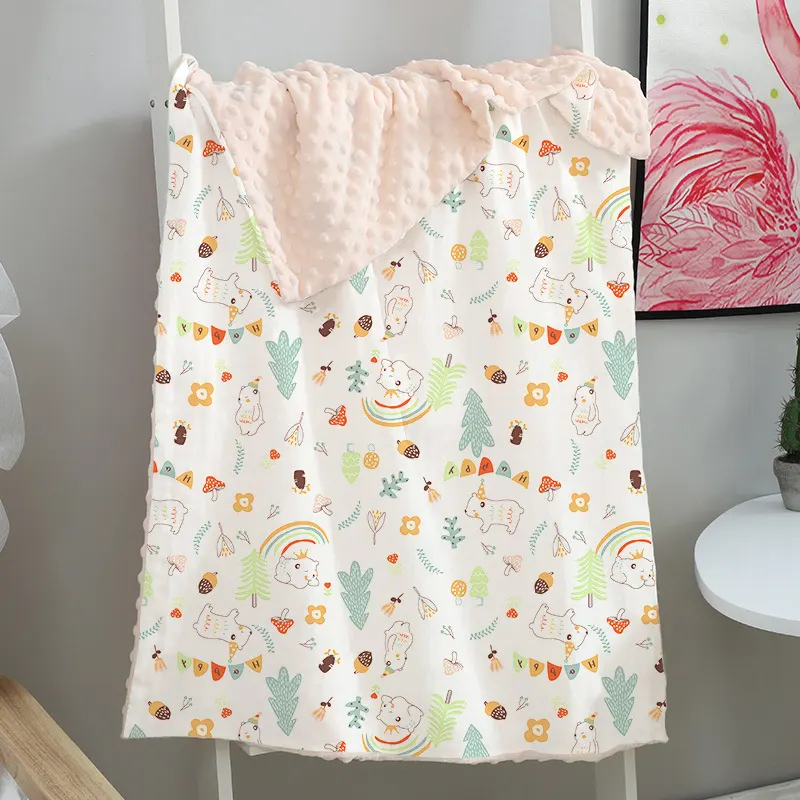 Pink double-layer baby blanket with dotted backing, folded and laid flat