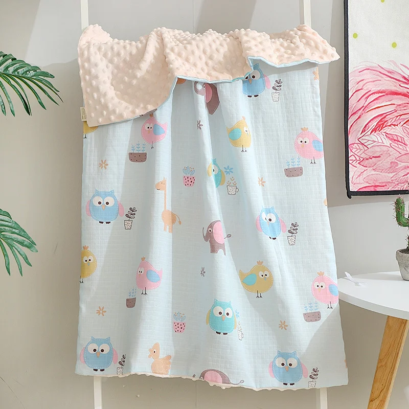 Brown baby blanket with leaf and dot pattern, displayed in a gift-ready OPP bag