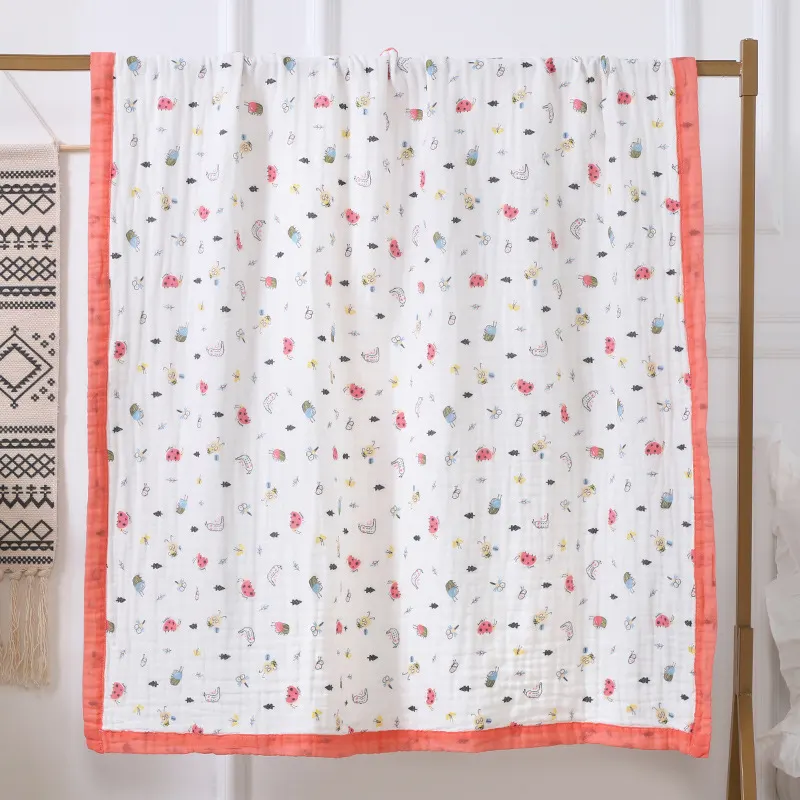 Green 6-layer cotton baby blanket with leaf pattern, folded in half
