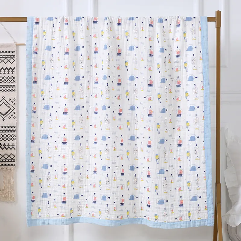 Blue 6-layer cotton towel with animal print, shown in use wrapping a baby