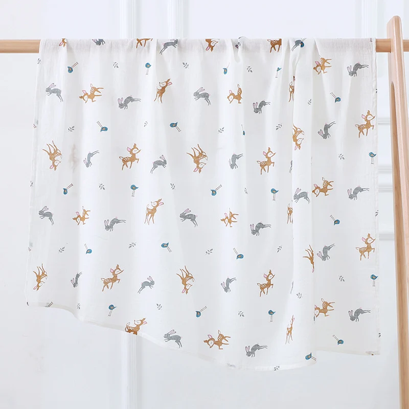 Swaddle blanket in animal pattern, used as a sunshade during outdoor tummy time