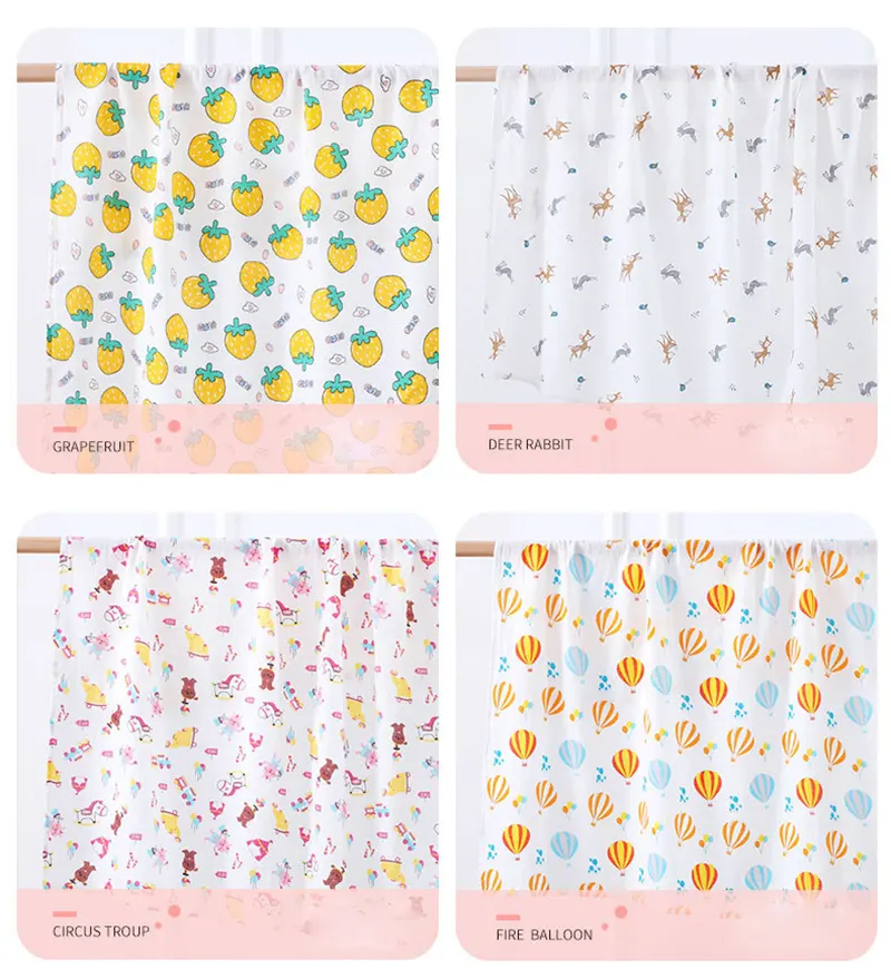 Swaddle blanket in cartoon pattern, draped over a baby’s back during nursing