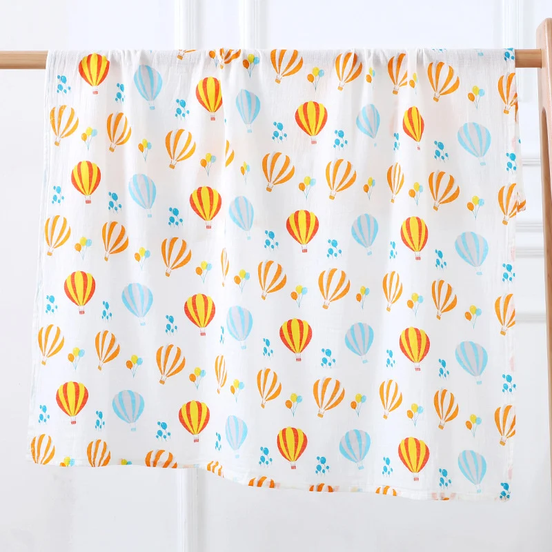 Swaddle blanket in plant pattern, shown with the four available unisex designs