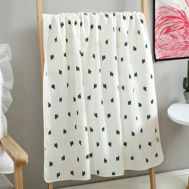 Red cartoon-patterned cotton muslin blanket with folded edges
