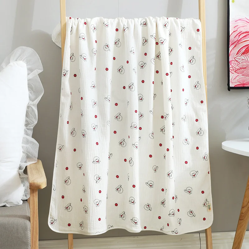 Multi-coloured cotton muslin blanket with mixed patterns in a retail display