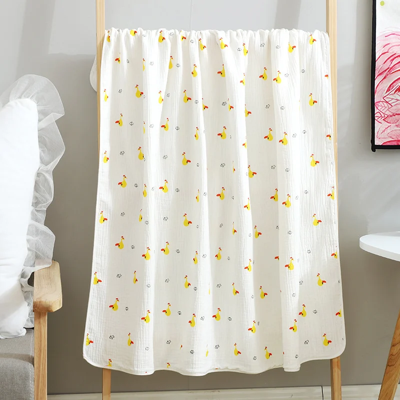 Yellow leaves-patterned cotton muslin blanket with visible weave texture