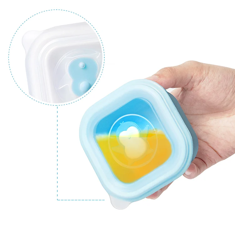 Set of four 200ml silicone containers in pink and blue, standing upright