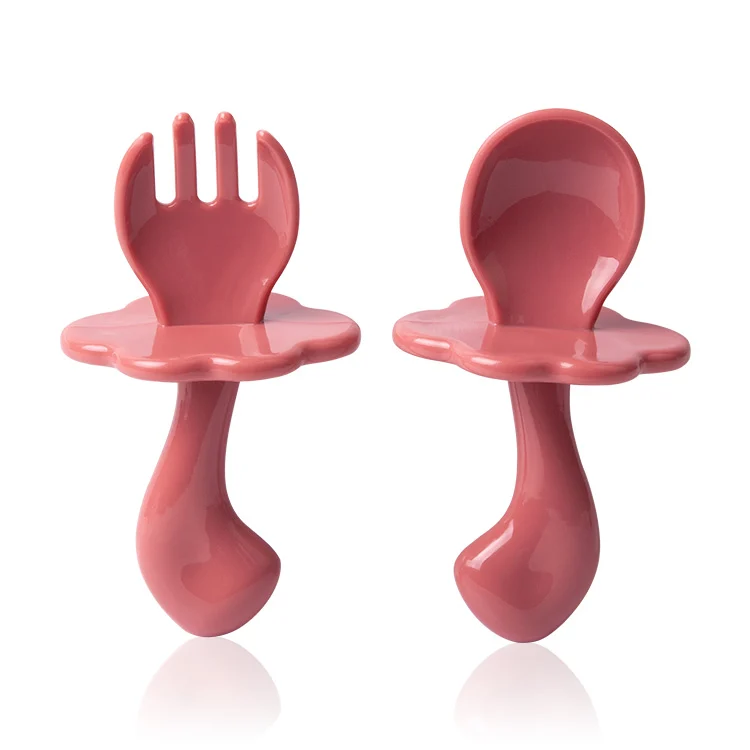 Yellow baby feeding spoon and fork set in a close-up view