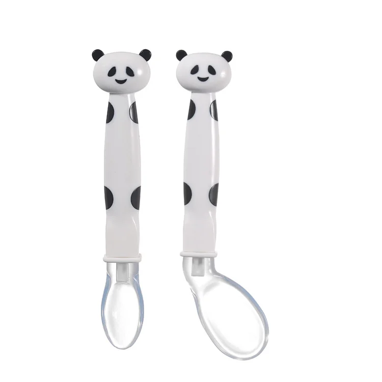 Two panda-themed silicone feeding spoons with soft tips, standing upright in a PP storage box