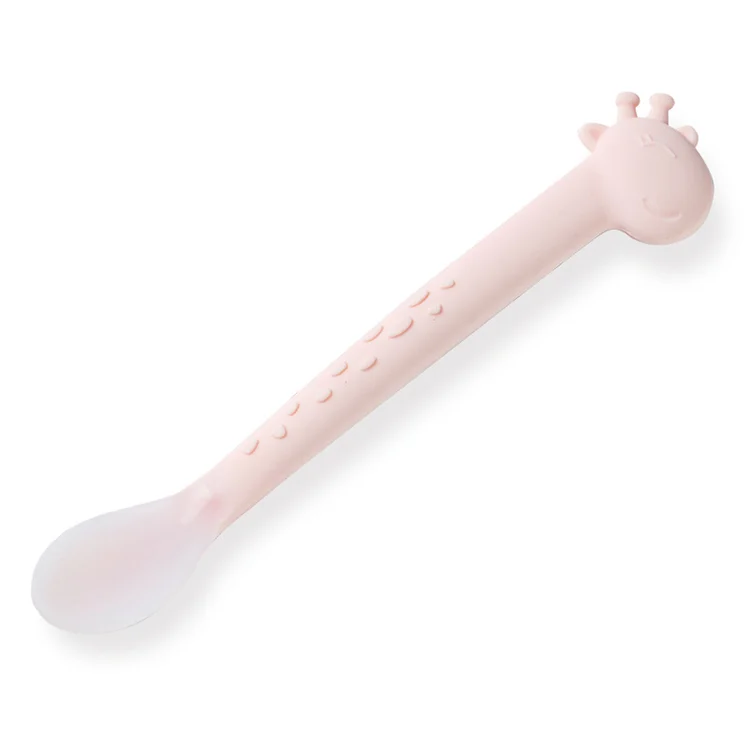 Feeding spoon standing upright with handle and textured base visible