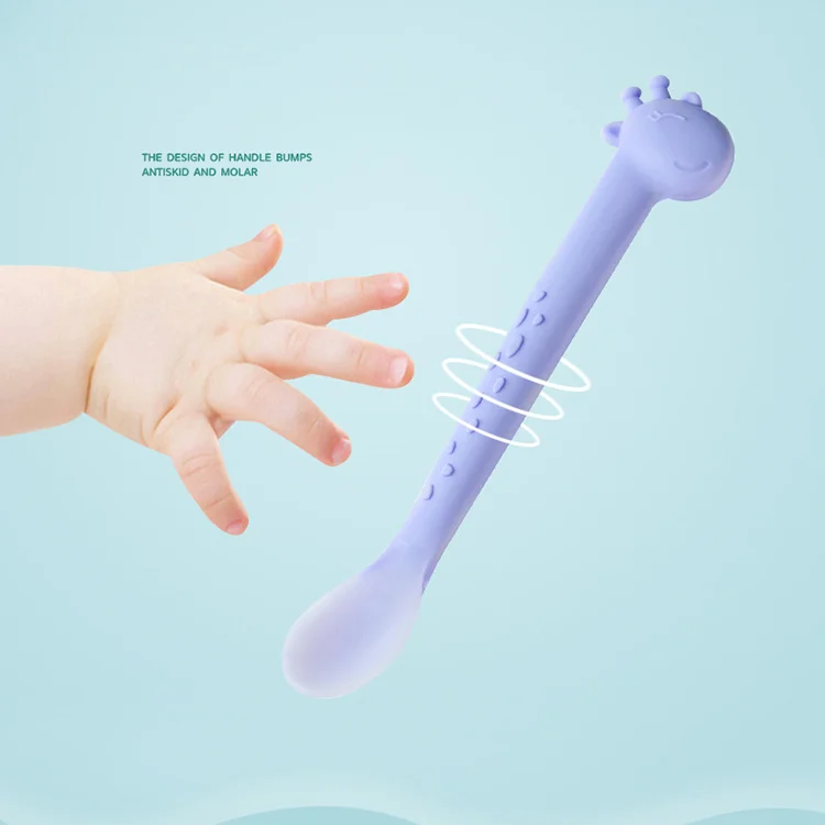 Feeding spoon in pink, placed on a clean surface with OPP bag