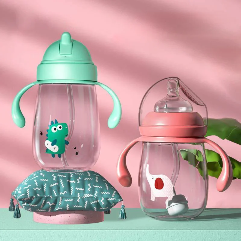 Pink baby feeding bottle with rotating handle, open cap, and silicone nipple attached