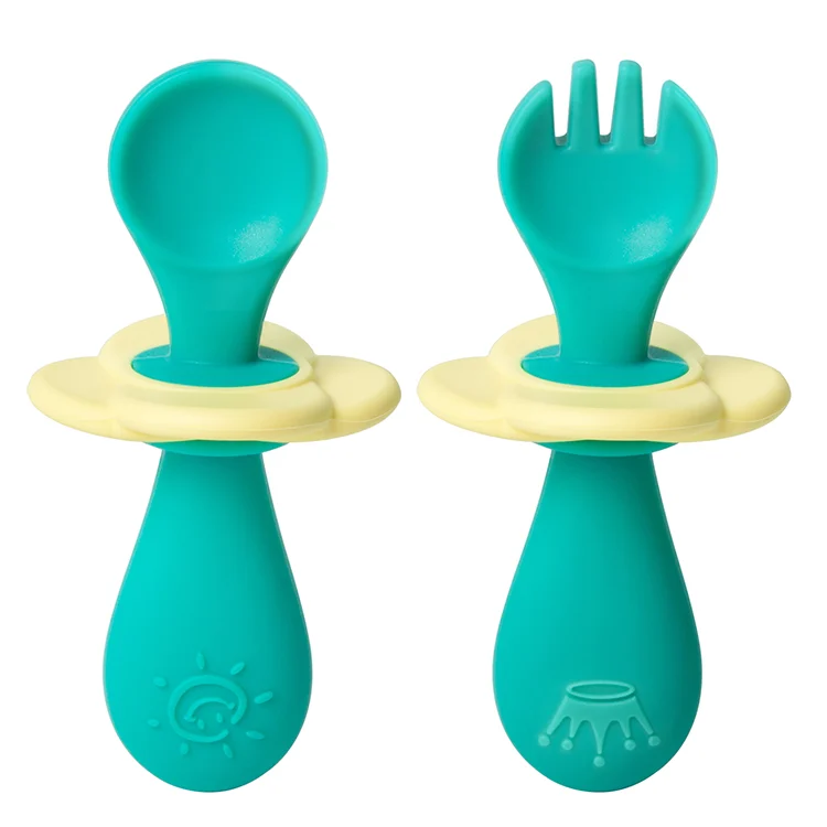 Green infant silicone fork and spoon set with baffle in place, inside transparent PP case