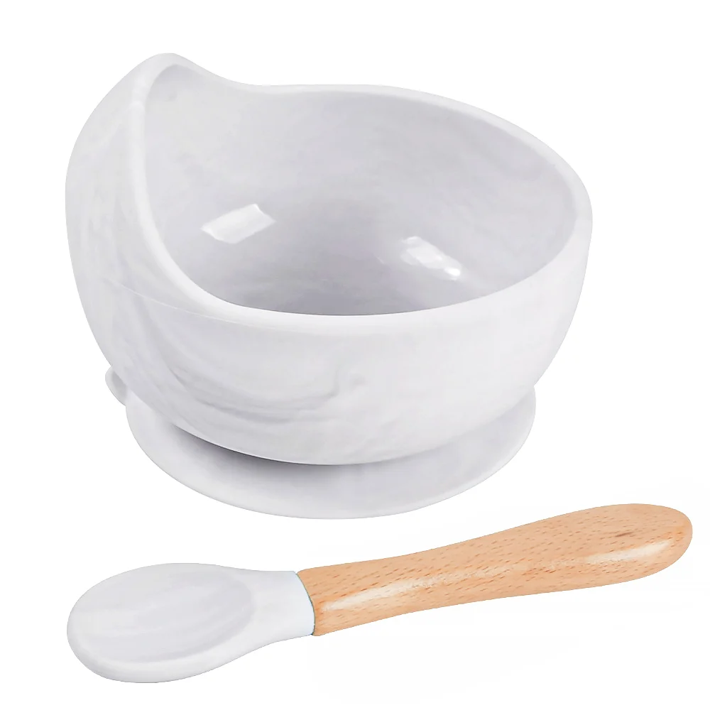 Blue silicone bowl with suction base on a white table