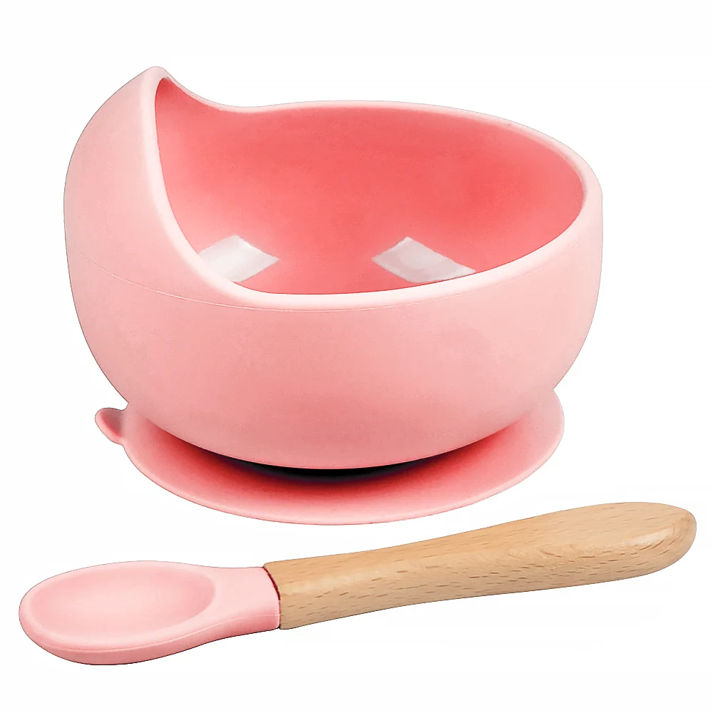Green silicone bowl with spoon placed beside it