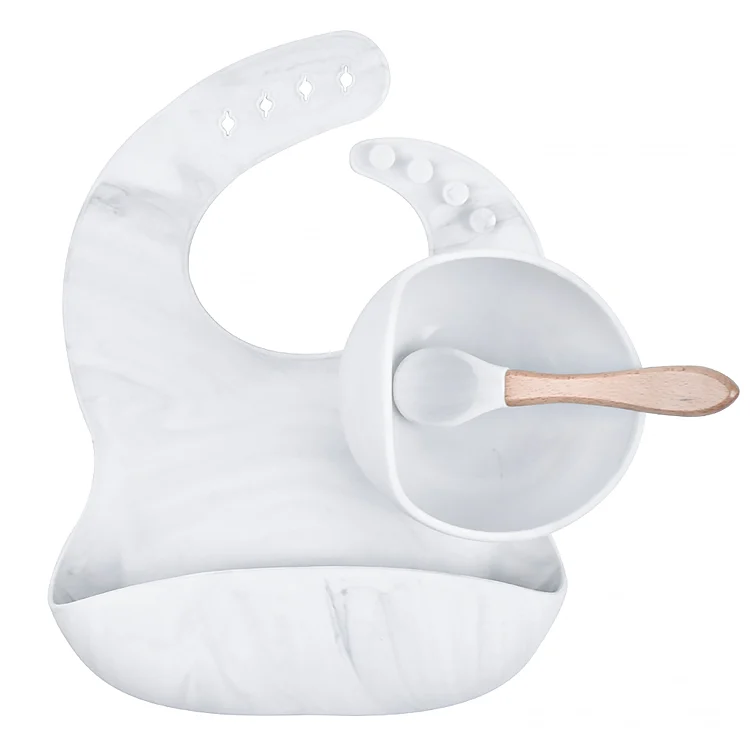 Silicone baby bowl with suction cup on a flat surface, showing strong adhesion