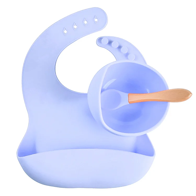 3-in-1 silicone feeding set with suction bowl, adjustable bib, and spoon in use on a high chair