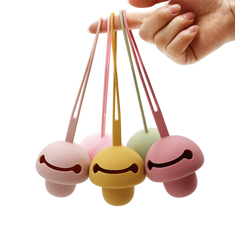 Side view of the pacifier holder case showing the soft silicone body and integrated strap