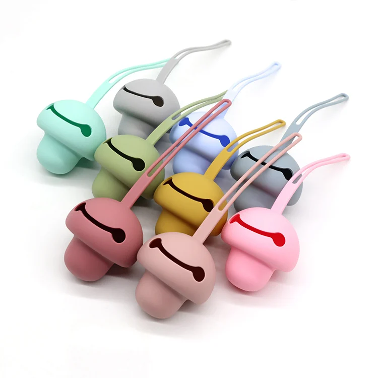 Transparent silicone pacifier holder case with two pacifiers inside, attached to a stroller strap