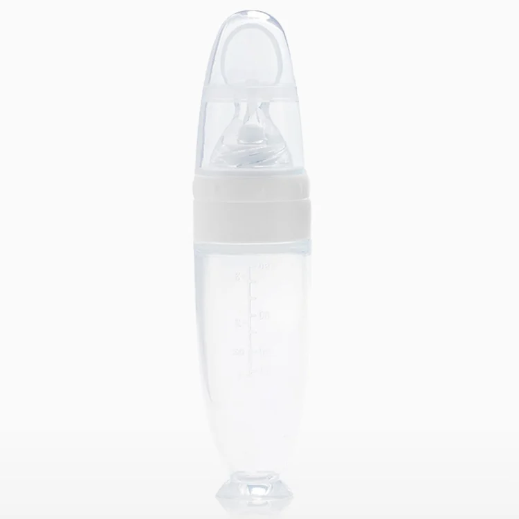 Baby spoon feeder standing upright with the suction cup base secured