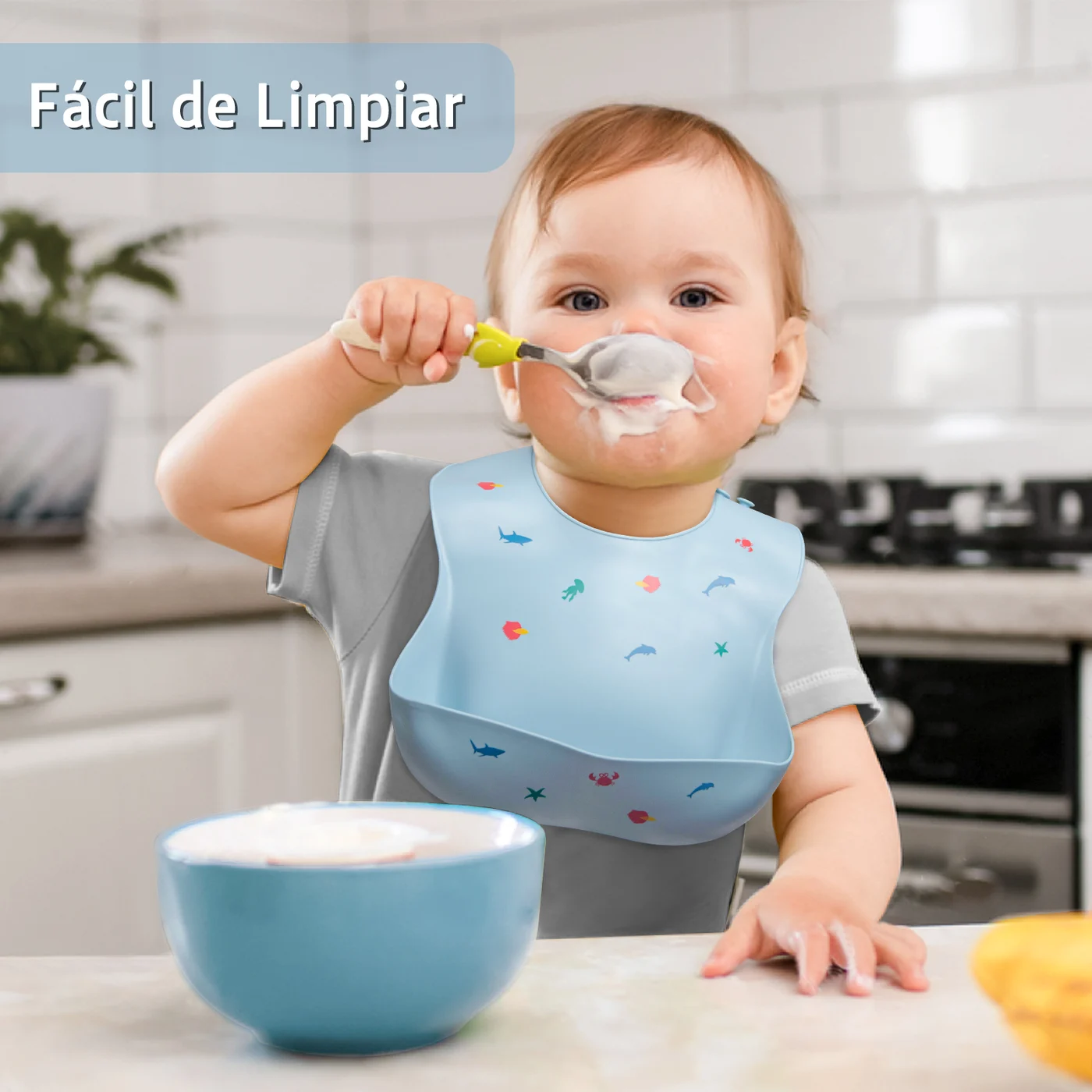 Blue silicone baby bib with food catcher pocket, worn on a mannequin