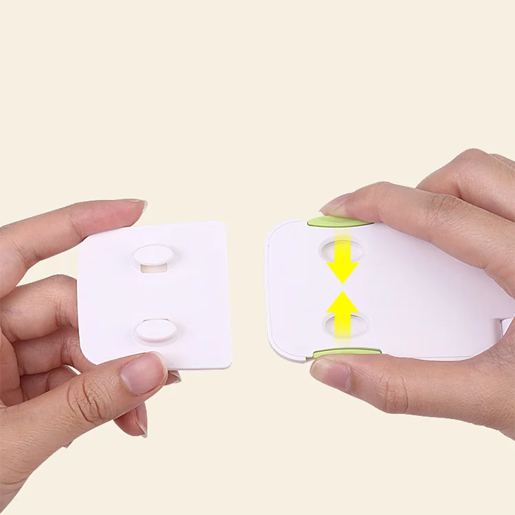 Green safety lock with adhesive backing visible