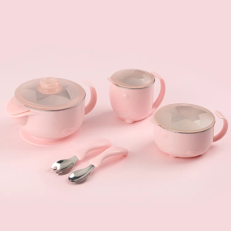 Pink 5-piece baby feeding set with stainless steel bowl, cup, spoon, fork, and silicone lid on a white surface