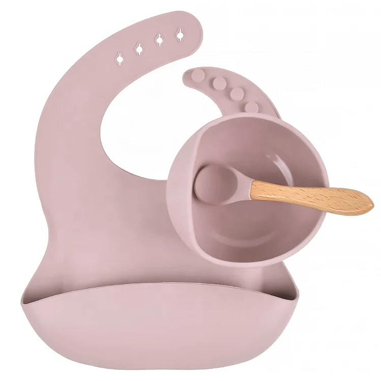 Silicone baby bowl with suction cup attached to a high chair surface
