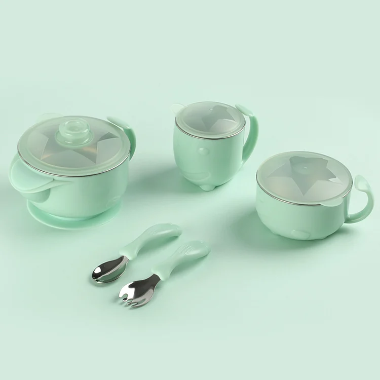 Green baby feeding set with bear design on bowl and cup, showing suction base