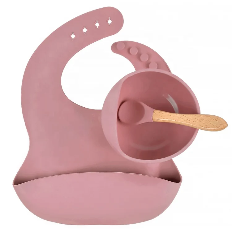 Baby feeding set with suction base bowl, silicone spoon, and adjustable bib on a high chair