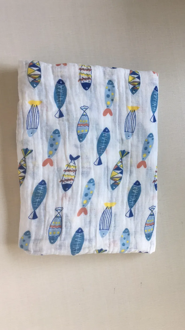Colorful fish pattern swaddle blanket, shown in a baby car seat cover use case