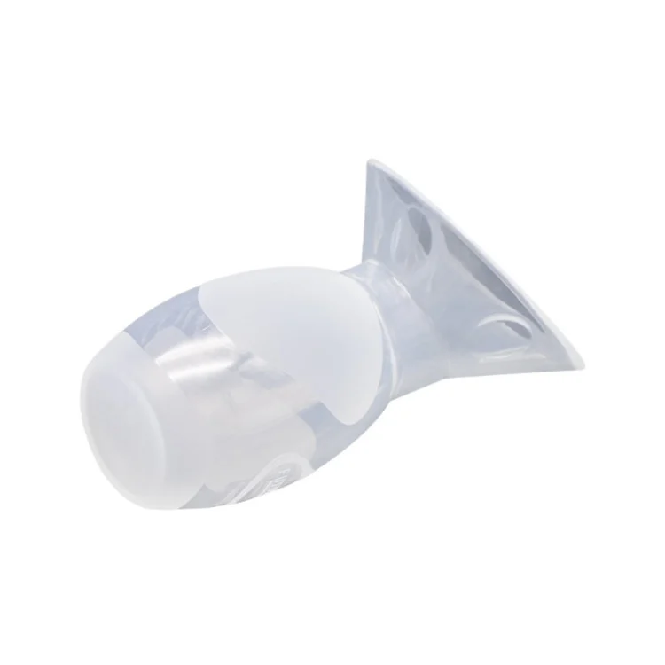Manual breast pump placed on a flat surface with the funnel facing up
