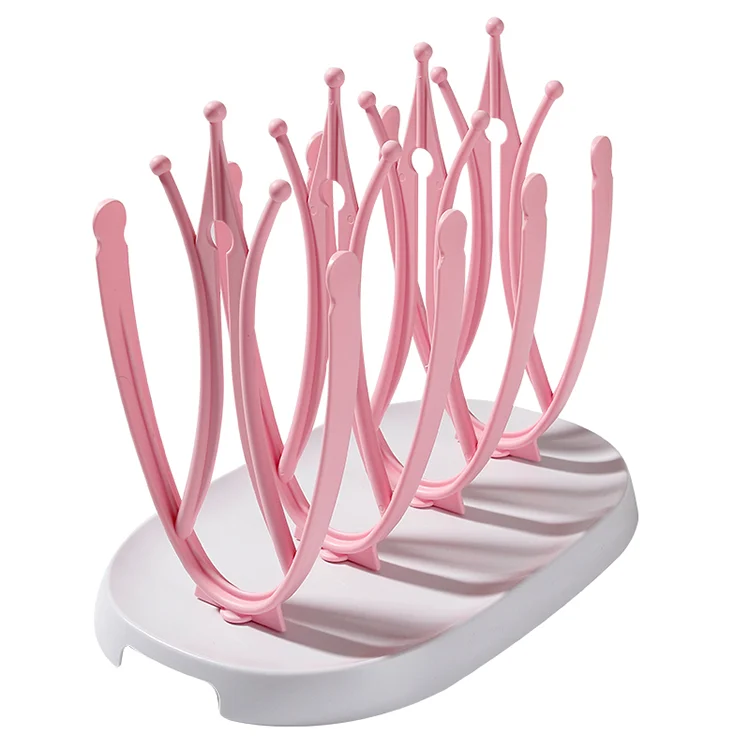 Pink baby bottle drying rack with removable drip tray in water-collecting position