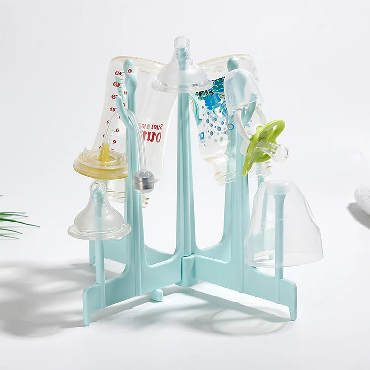 Blue baby bottle drying rack with bottles and teats placed on branches