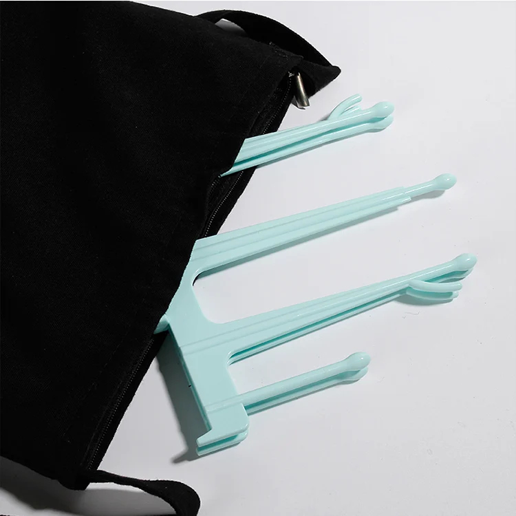 Blue baby bottle drying rack with bottles and pump parts on branches