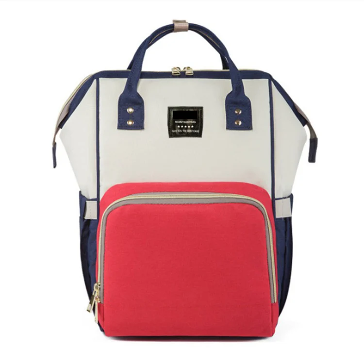 Diaper bag backpack in a neutral grey colour, worn by a parent