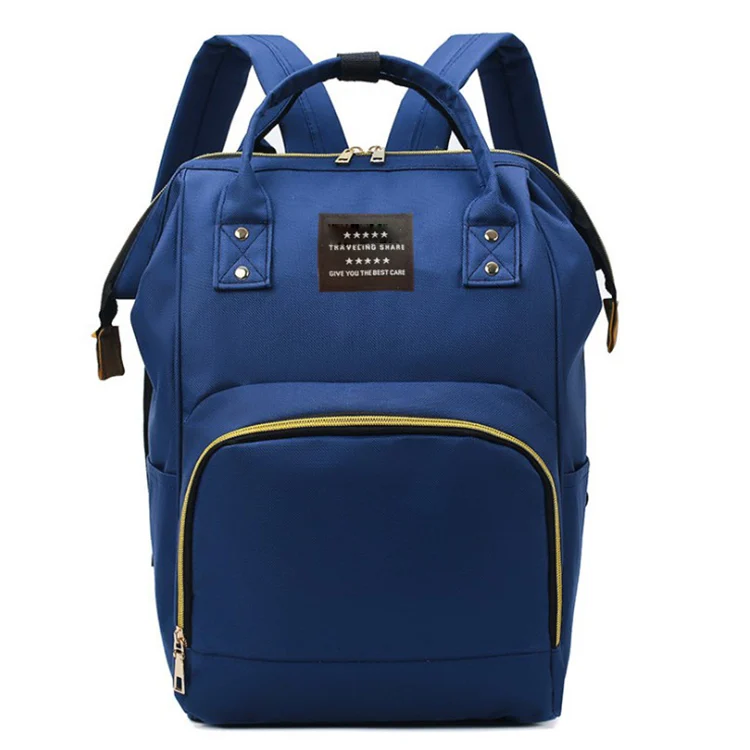 Diaper bag open showing separate storage compartments for bottles, diapers, and wipes