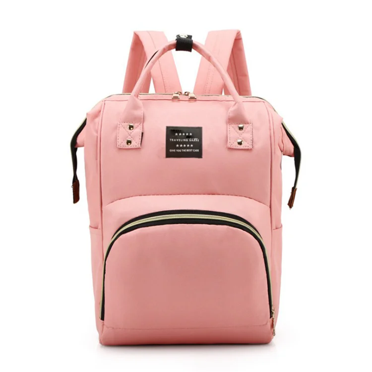 Diaper bag closed with zippered back flap and shoulder straps adjusted