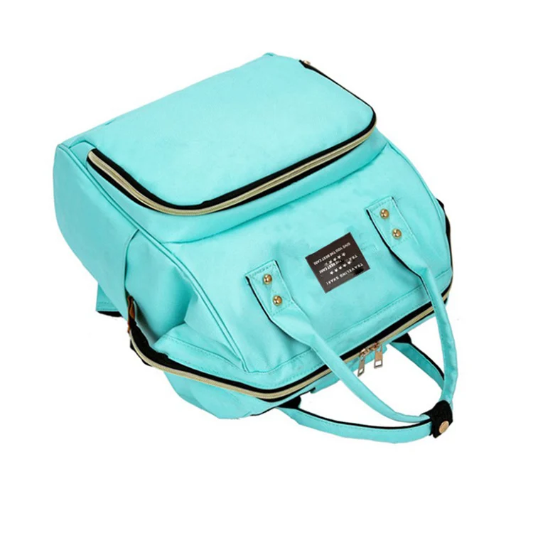 Diaper bag with a bottle and diaper pack inside, displayed on a clean surface