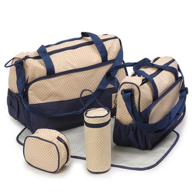Diaper bag standing upright with internal pockets visible