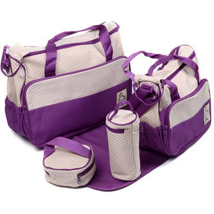 Diaper bag open showing separate compartments for bottles, diapers, and wipes