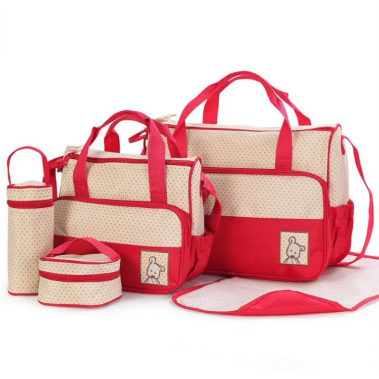 Diaper bag placed in a shopping cart with handle visible