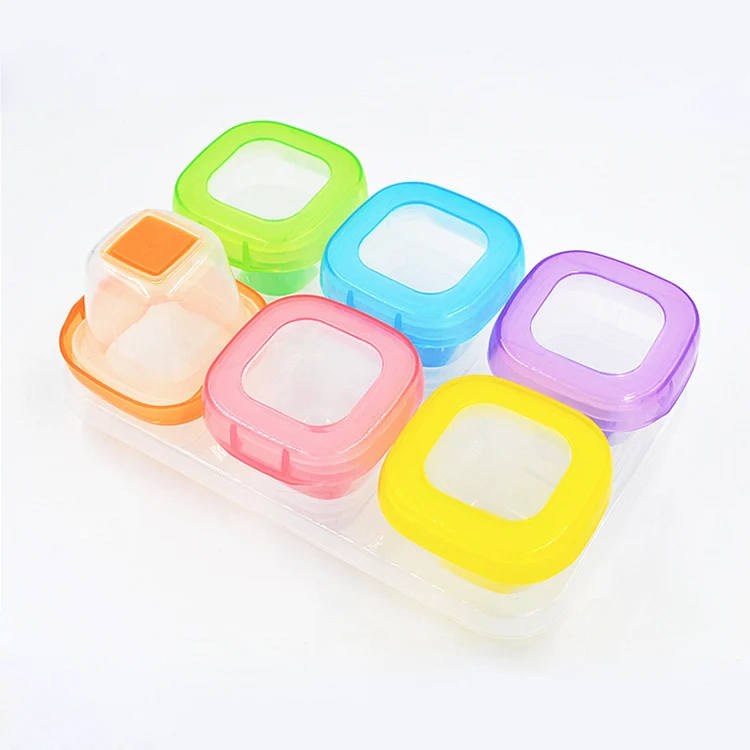 Six clear 60ml baby food storage containers with lids closed, arranged in a row
