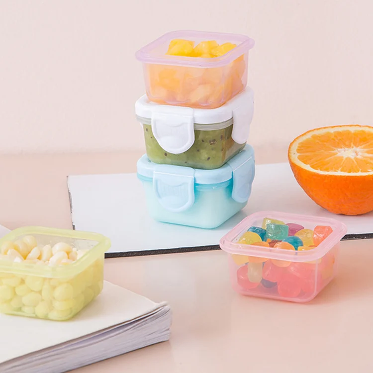 Transparent 60ml baby food container with lid removed, showing interior