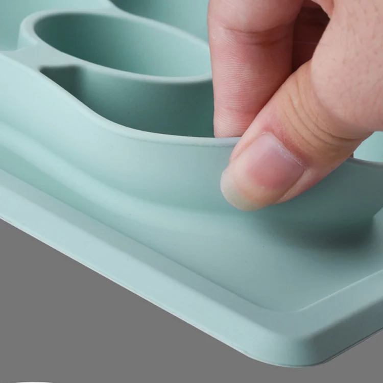Silicone spoon and plate set on a table with food inside