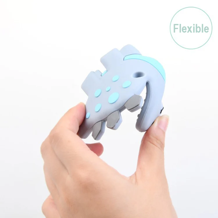 Stegosaurus silicone teether toy in green, with the OPP bag packaging